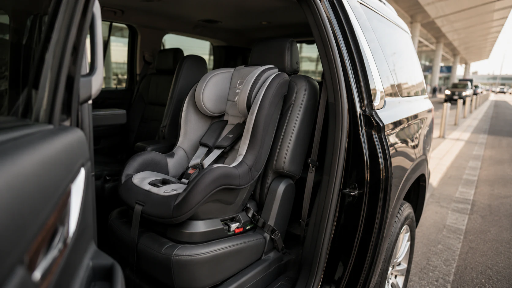 Child car seats inside an Airport Black Limo Chevrolet Suburban